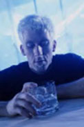 Depressed man looking at drink